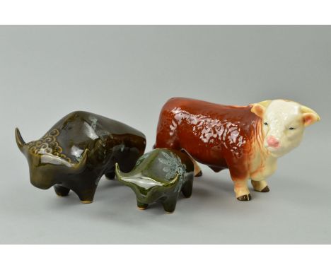 A MELBA WARE HEREFORD BULL, approximate length 26cm and two studio 'Lotus' pottery bulls, approximate lengths 22cm and 17cm, 