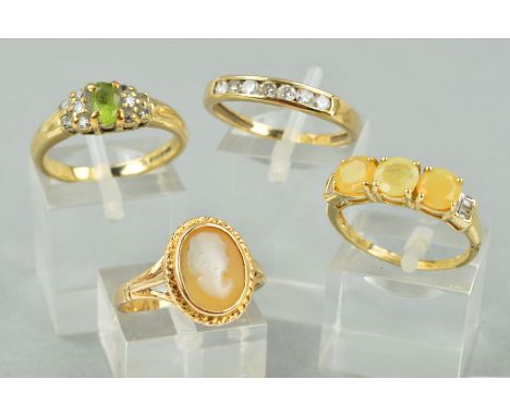 FOUR 9CT GOLD RINGS to include a cubic zirconia half eternity ring, ring size P, a cameo ring, ring size M 1/2, a three stone