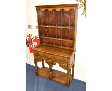 A TITCHMARSH AND GOODWIN OAK DRESSER with a two tier plate rack above five various drawers, on shaped uprights united by an u