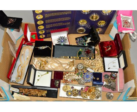 A BOX OF COSTUME JEWELLERY to include a Christian Dior blue paste bracelet, Celtic design Miracle brooches, imitation pearl j