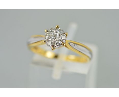 A DIAMOND CLUSTER RING designed as a central brilliant cut diamond surrounded by six further brilliant cut diamonds, stamped 