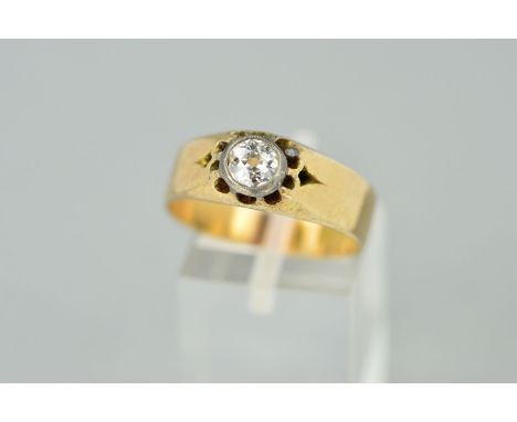 A DIAMOND RING designed with a collet set brilliant cut diamond to a claw surround and wide band, estimated diamond weight 0.