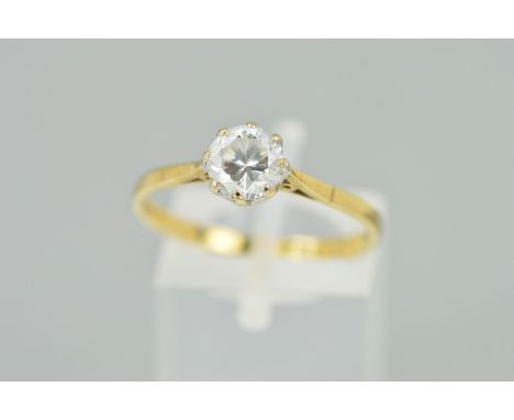 A 9CT GOLD CUBIC ZIRCONIA SINGLE STONE RING, designed as a circular claw set cubic zirconia to the tapered shoulders and plai