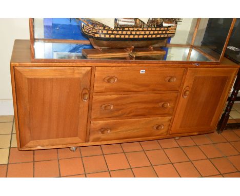 AN ERCOL ELM 1960'S SIDEBOARD, with three drawers central to two cupboards doors, approximate width 155cm x depth 44cm x heig