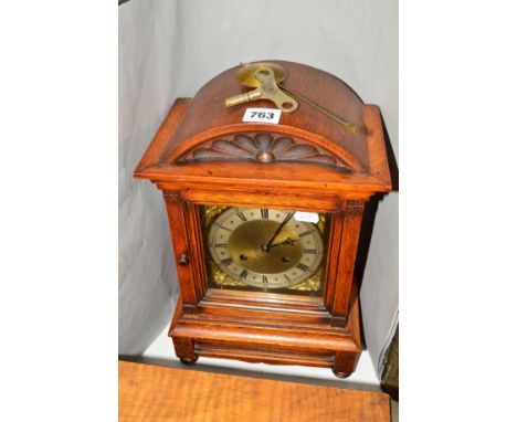 A LATE 19TH CENTURY OAK CASED DOME TOP EIGHT DAY MANTEL CLOCK, brass and silvered dial with Roman numerals, gong strike, heig