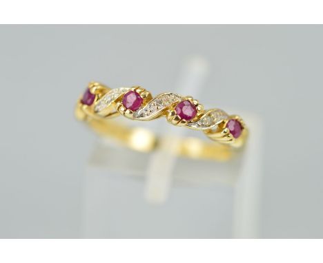 A 9CT GOLD RUBY AND DIAMOND RING designed as four circular rubies interspaced by tapered diagonal panels each set with single