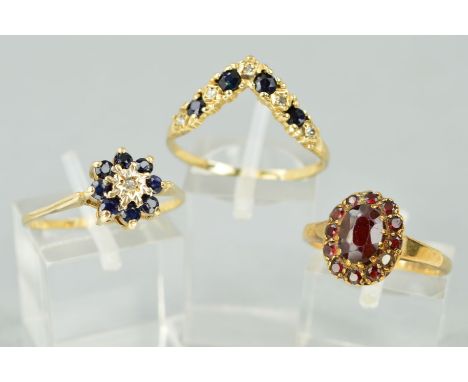 THREE DRESS RINGS comprising of a 9ct gold sapphire and diamond wishbone ring, a sapphire and diamond round cluster ring and 