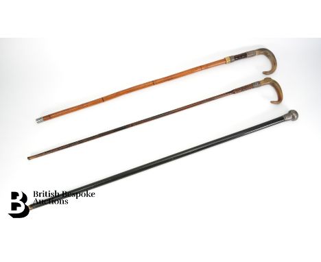 Three silver walking sticks; a hammered silver handled walking cane, hallmarked London dated 1922 mm PA; a horn handle and si