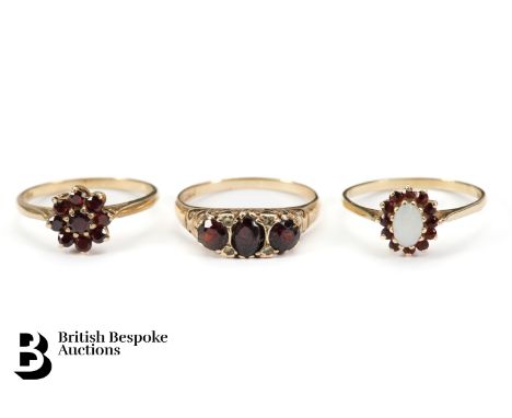 9ct gold and garnet cluster ring, size R; a 9ct three stone opal ring, size Q and a 9ct gold garnet cluster ring P+, approx 7