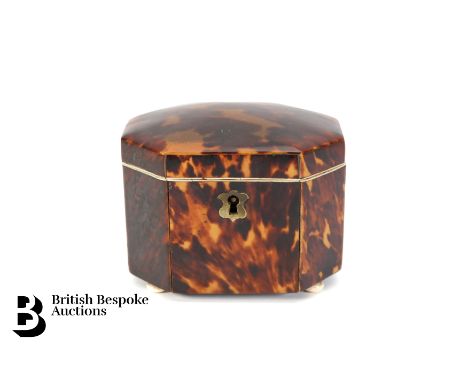 A small tortoiseshell tea caddy, approx 11 x 9 x 8 cms, supported on four bone bun feet.&nbsp;Condition ReportSplit to top, p
