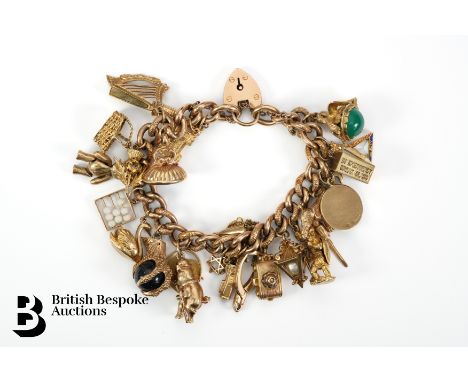 9ct gold curb link charm bracelet, the bracelet benefiting from twenty four 9ct gold charms, with a gate link clasp, approx 9