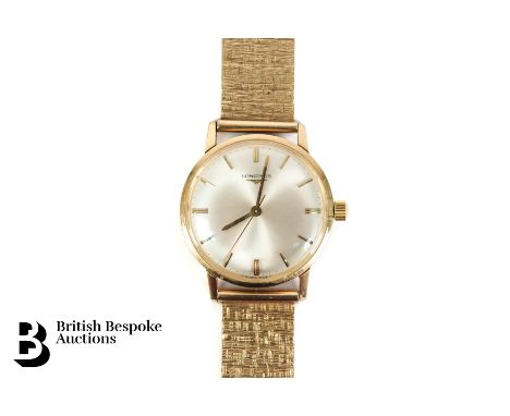 Gentleman's 9ct yellow gold Longines wrist watch, on a 9ct gold bark finish watch strap. The watch having 30mm champagne face