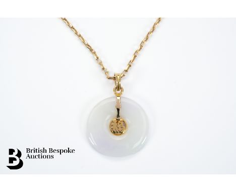 A Chinese 14ct white jade disc pendant, 25mm, suspended from a 9ct gold chain, approx 44 cms, 3.4 gms.&nbsp;