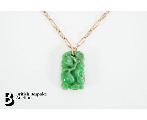 A 9ct yellow gold chain with a carved Imperial jade pendant, approx 23 x 14 cms. Necklace measures approx. 42cms. Chain weigh