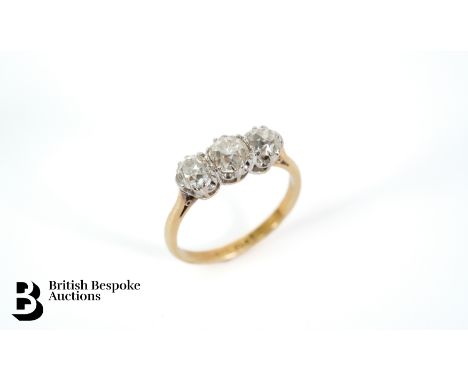 An antique 18ct gold and platinum three stone diamond ring, set with a 60pt old cut flanked by two 40 pts dias, size N, appro