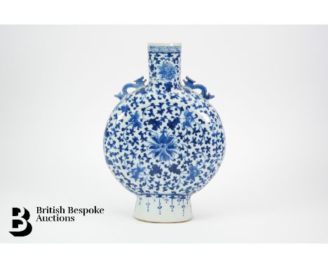 A Chinese blue and white moon flask, Qing Dynasty, profusely painted with arabesque, with serpent handles, approx 29 cms. (af