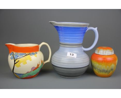 A Clarice Cliff 'Bizarre' pattern jug, a Shelley pottery jug and a further unmarked Shelley ginger jar, tallest H. 23cm.