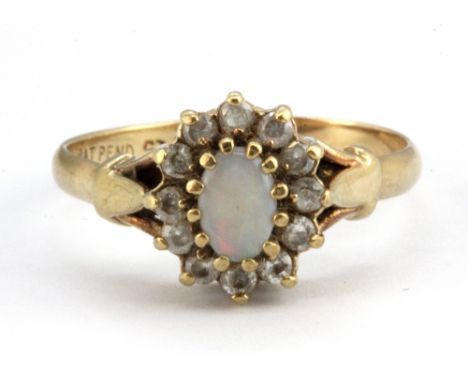 A 9ct yellow gold opal and white stone cluster ring, (P.5).