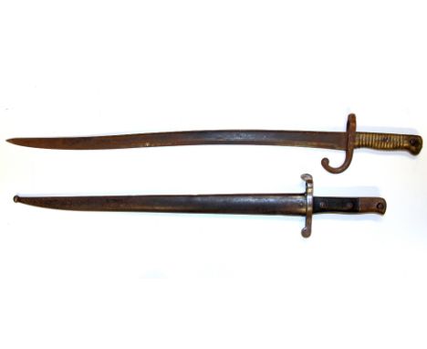 Two 19th Century bayonets, one with scabbard, L. 70cm L. 61cm.