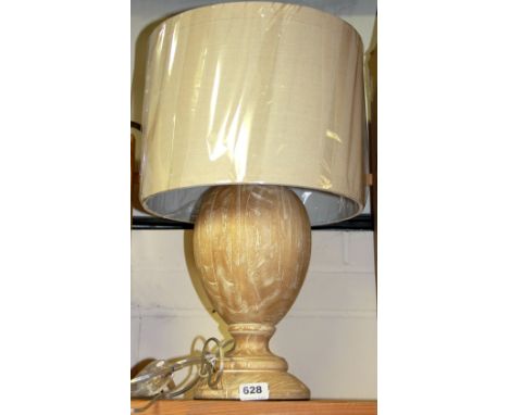 A contemporary wooden table lamp with beige linen shade, H. 54cm.