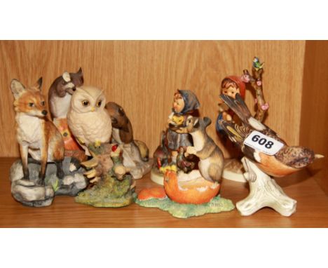 Three Goebel pottery figures and five Scottish resin figures.