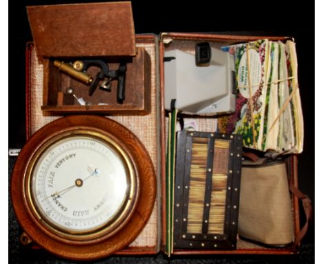 A case containing a quantity of interesting items including a polaroid camera, a miniature microscope etc.