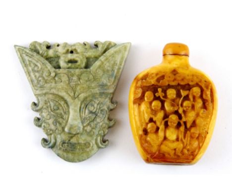 A Chinese carved bone snuff bottle together with a carved nephrite jade amulet, H. 7cm.