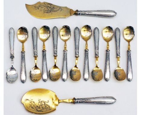 A fine French Louis XVI style silver gilt / vermeil dessert or ice cream flatware set comprising of twelve spoons and two ser