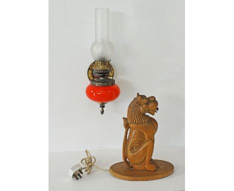 A wall sconce in the shape of an oil lamp, the red glass base mounted with brass, the chimney in frosted glass H38cm, togethe