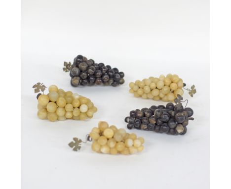 A Chinese set of five grape clusters, two of red grapes and three of white, made of jade, mid 20th century, L14cm. (5)