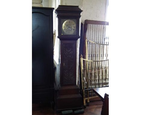 Longcase clock by Wooley with brass dial and carved oak case.