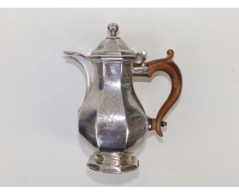 A Queen Anne Britannia Standard silver covered milk jug of octagonal baluster form, the domed hinged cover with ball finial, 