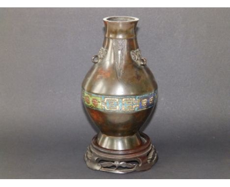 A small Chinese enamelled bronze vase in archaic taste, the neck with small ring handles above a band of enamelled decoration
