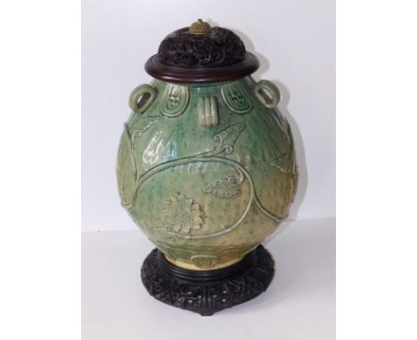 A Chinese provincial celadon glazed jar, of rounded form with five small loop handles, applied arabesque leaf scroll to the s