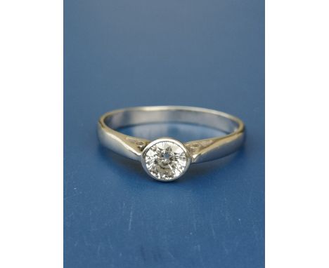 A diamond solitaire ring, the collet set brilliant cut stone weighing approximately 0.55 carat in 18ct whit gold.  Finger siz