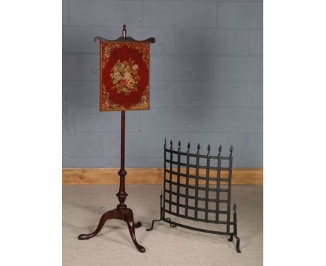 Victorian mahogany pole screen, having needlework panel, turned column and tripod legs, together with a wrought iron pierced 