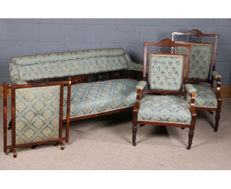 Edwardian rosewood inlaid salon suite, comprising settee, pair of open armchairs, and fire screen, all having pierced fret ca