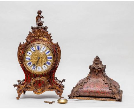 A 19th Century French red Boulle bracket clock with Putti seated above the waisted case with ormolu mounts, circular brass di