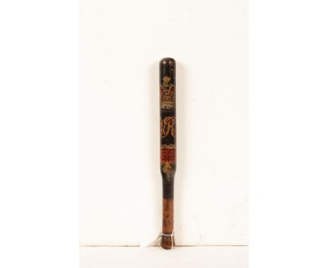 A Victorian turned wood and painted truncheon, black painted with a painted crown above the VR monogram and a red cartouche l