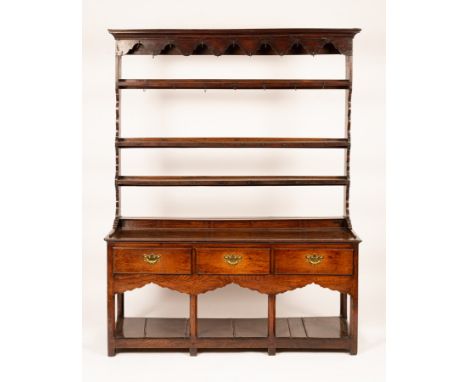 A George III oak pot board dresser, probably South Wales, the open plate rack above a three-drawer base on chamfered legs, 16