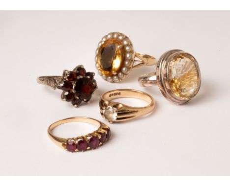 A ruby five-stone ring, the row of graduated stones in claw settings to an unmarked yellow metal shank, size O, approximately