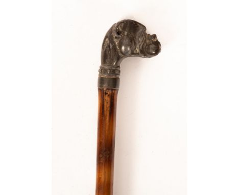 A cane walking stick, the spelter finial in the form of a boxer's head, 86cm long CONDITION REPORT: Condition information is 