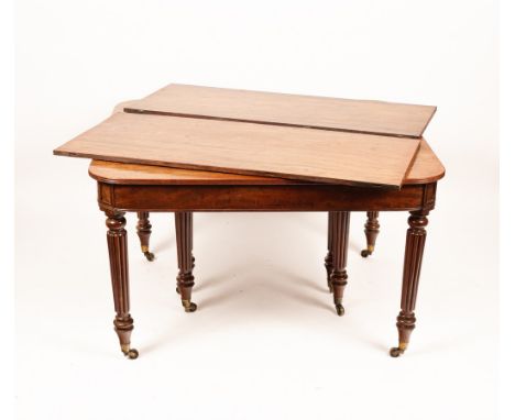 A Regency mahogany extending dining table, the rectangular top with a reeded edge and rounded corners, with plain frieze and 