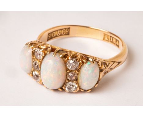 An 18ct gold diamond and opal set ring, the three opals interspersed by six small diamonds, approximately 6g in total, size Q