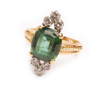 A contemporary green tourmaline and diamond ring, the cushion cut tourmaline approximately 11.11mm x 9.85mm x 6.19mm, flanked