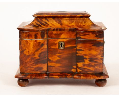 A 19th Century tortoiseshell and ivory inlaid tea caddy, the hinged moulded top with a brass plaque, opening to reveal two li