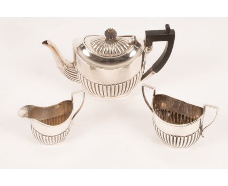 An Edwardian three piece silver tea service, John Henry Potter, Sheffield 1907, comprising a tea pot, a milk jug and a two ha