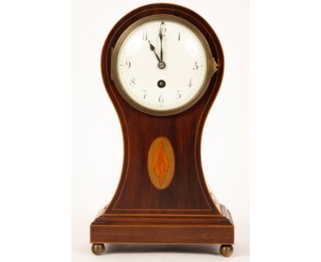 An Edwardian mahogany mantel clock in a balloon shaped case, banded in boxwood and inlaid an oval shell patera, fitted an eig