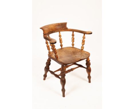 An early 20th Century elbow chair with dished elm seat CONDITION REPORT: Badly stained throughout. Bleached and split seat. B