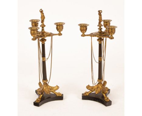 A pair of Regency style table candelabra, with figural surmount, three candle sconces and reeded column on triform base, 39.5